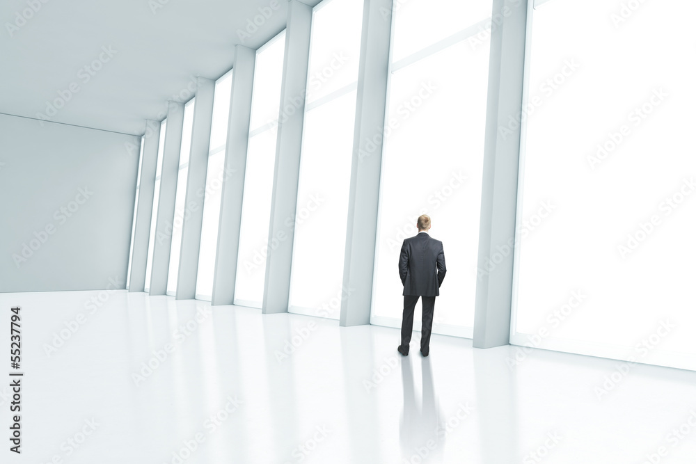 Businessman looking through the window Businessman looking through the window