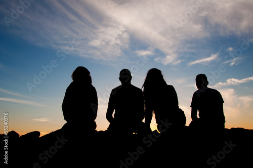Young people silhouettes at sunset