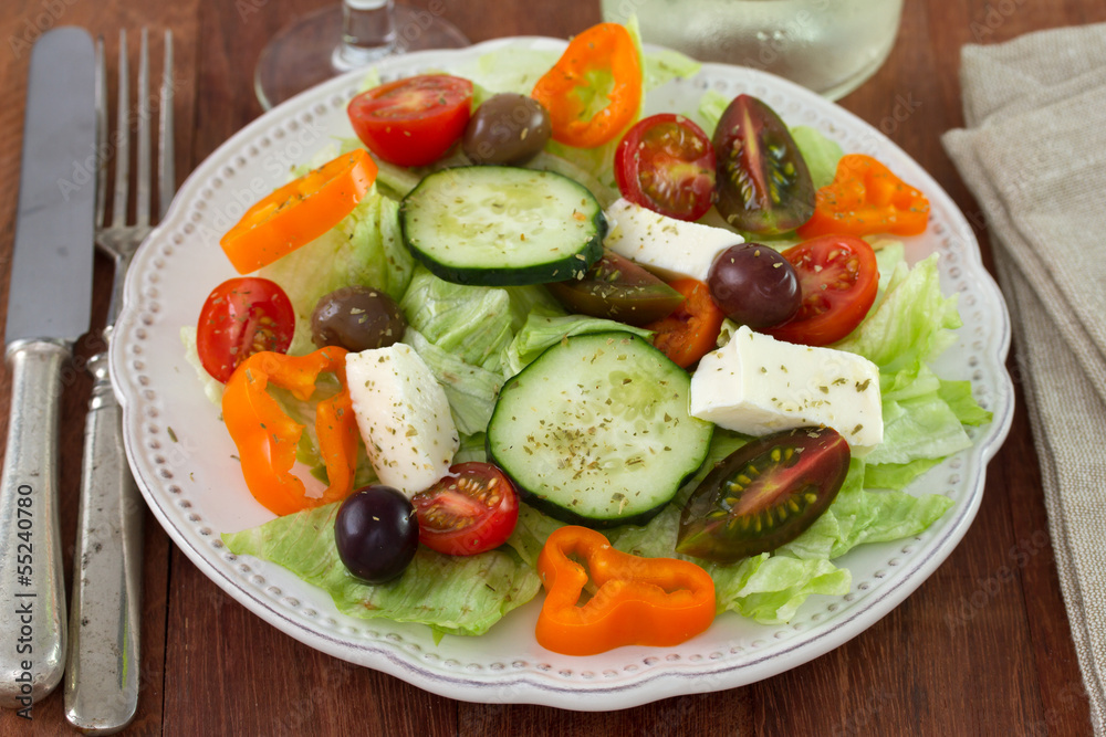 salad with cheese on the white plate