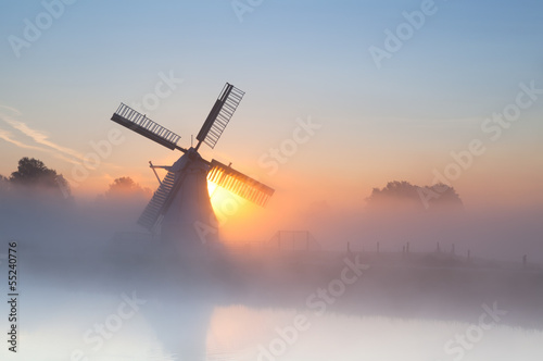 Dutch windmill in dense fog