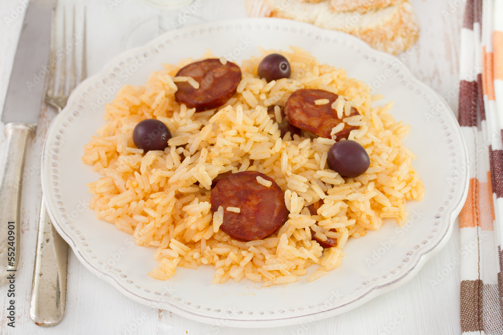 rice with sausages on the white plate