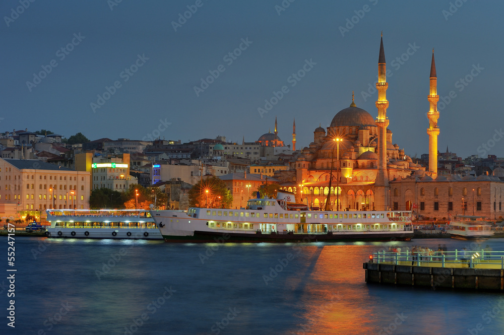 Yenicami - istanbul mosque and ferryboat in blue evening