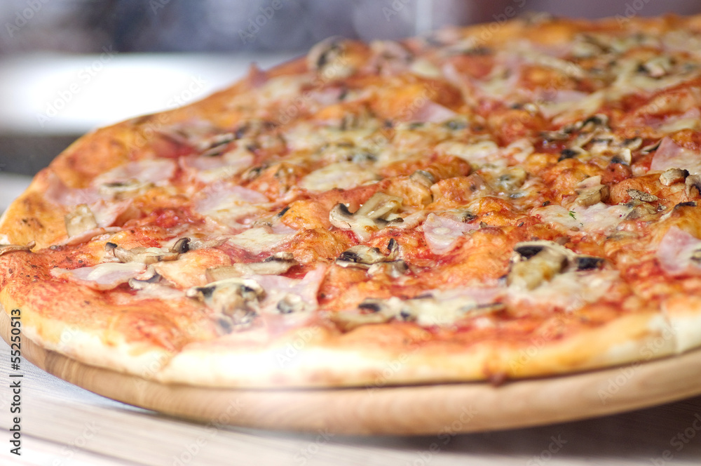 Pizza on the wooden plate