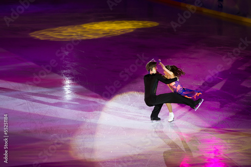 Beautiful pair perform an iceskating shot photo
