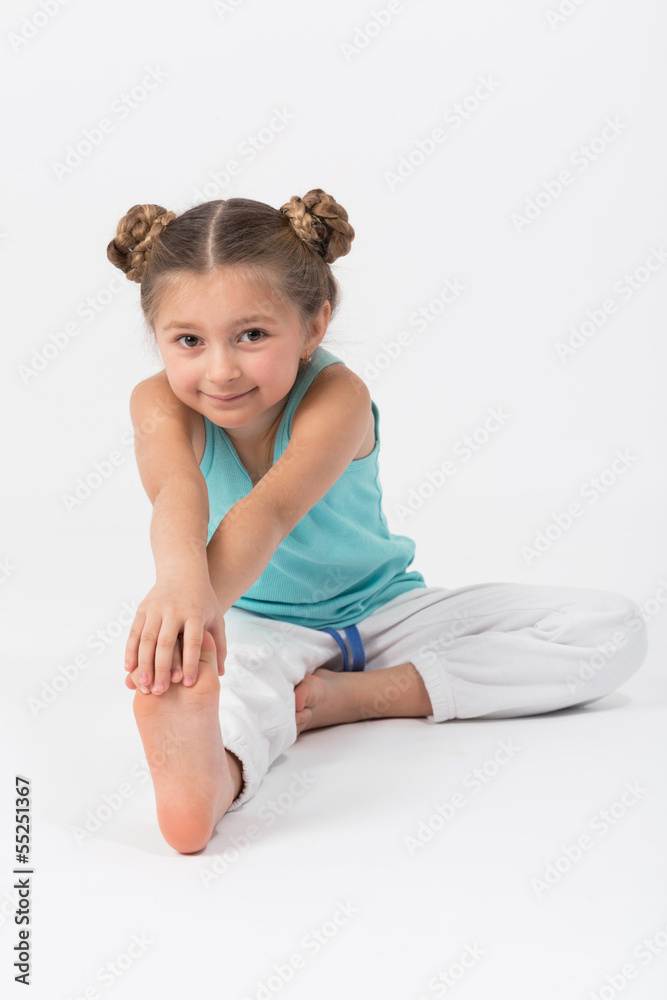 Girl doing gymnastics exercise sitting on the floor Girl doing gymnastics exercise sitting on the floor