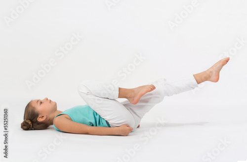 A girl makes gymnastic exercise lying on your back