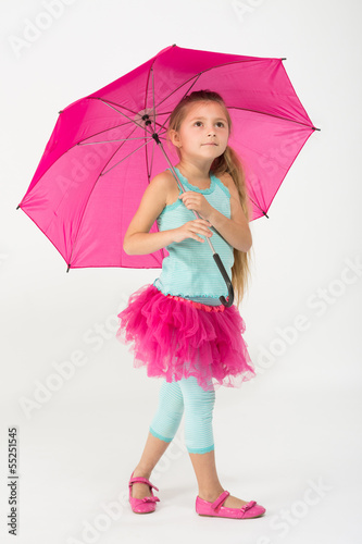 A girl in a pink skirt with a pink umbrella