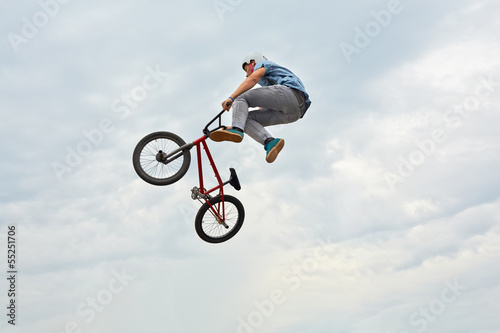 Boy jumps on bike