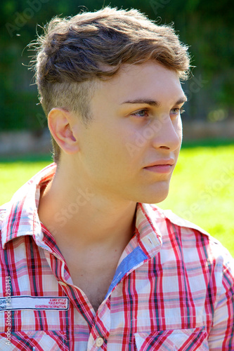 Serious young man looking in park