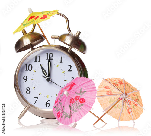 Vacation time concept. Alarm clock and cocktails umbrellas