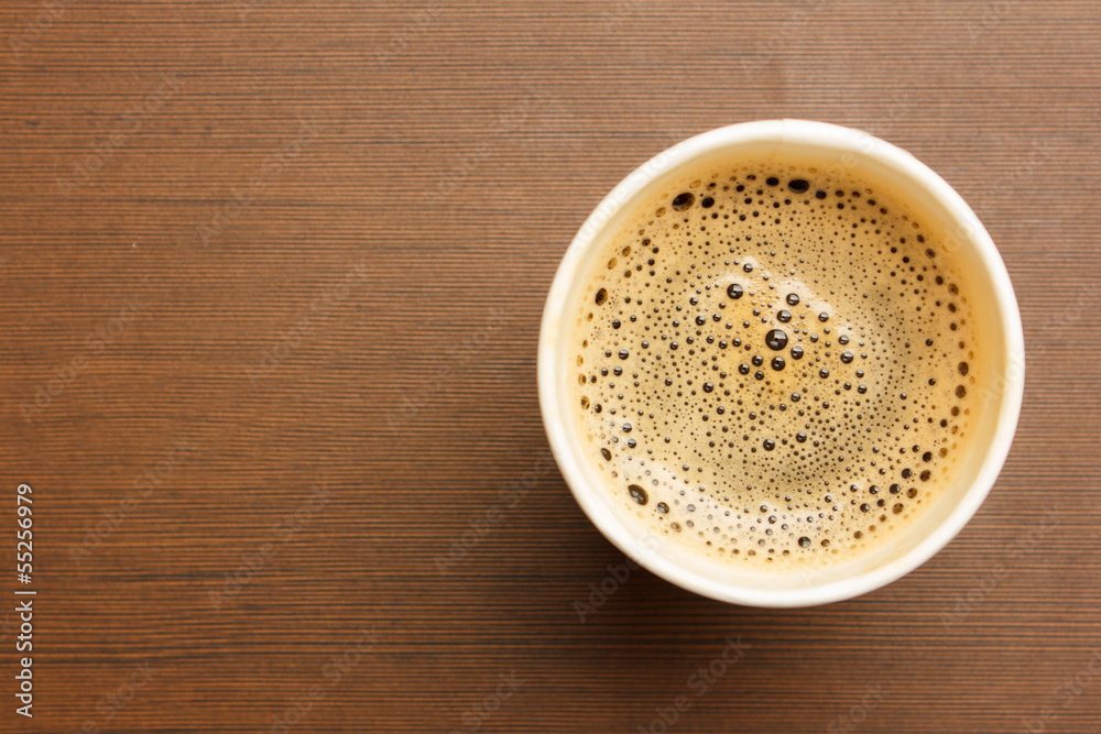 Top view of a cup of black coffee on wooden table Top view of a cup of black coffee on wooden table