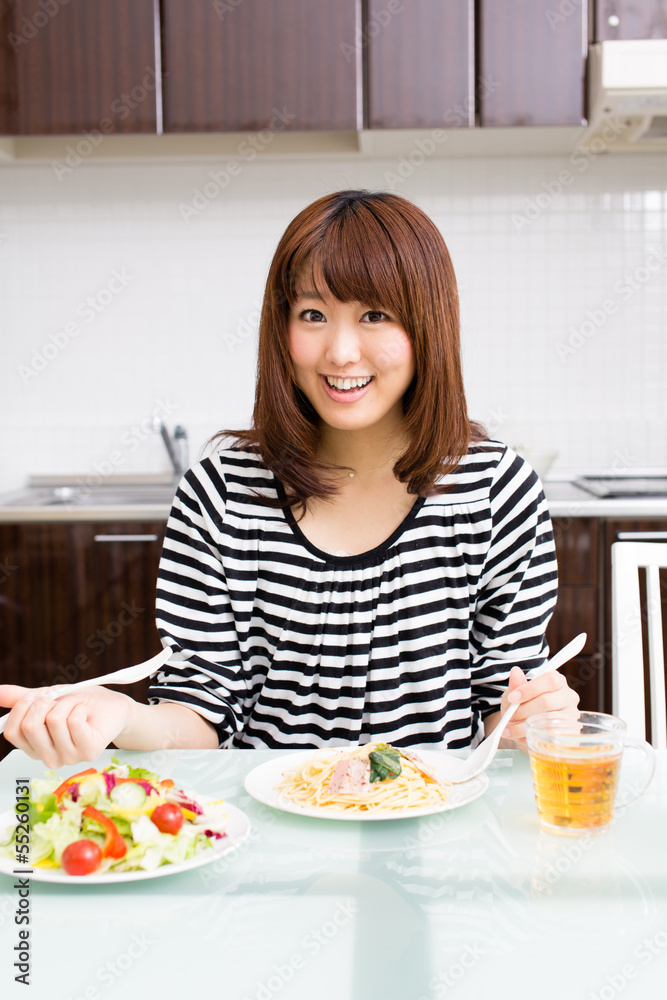 beautiful asian woman eating in the kitchen beautiful asian woman eating in the kitchen