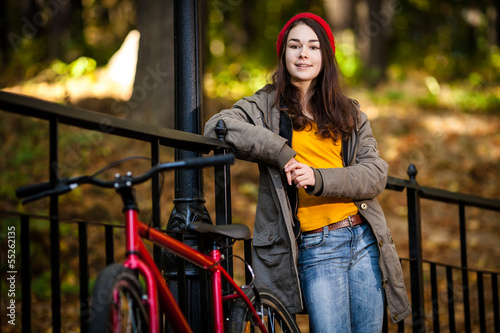 Urban biking - girl and bike in city park