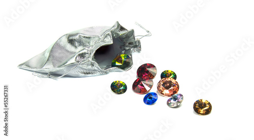 Fototapeta Naklejka Na Ścianę i Meble -  Faceted  crystals spilling from a velvet pouch isolated on white