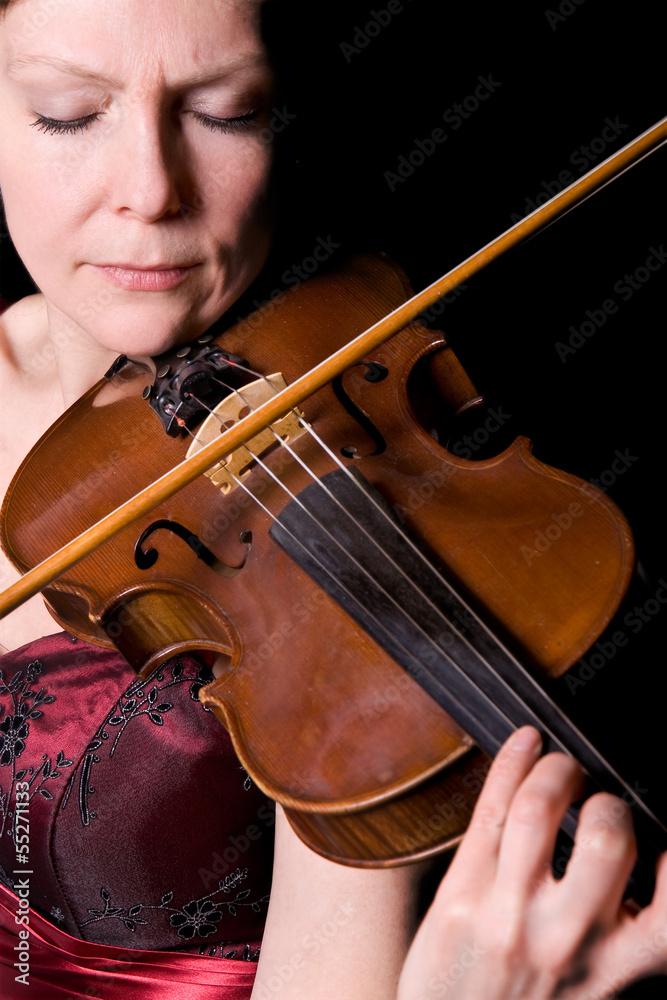 young woman plays the viola on black background young woman plays the viola on black background