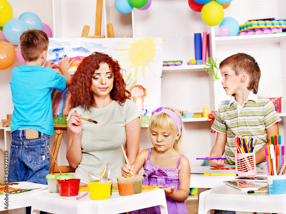 Fototapeta premium Child painting at easel.