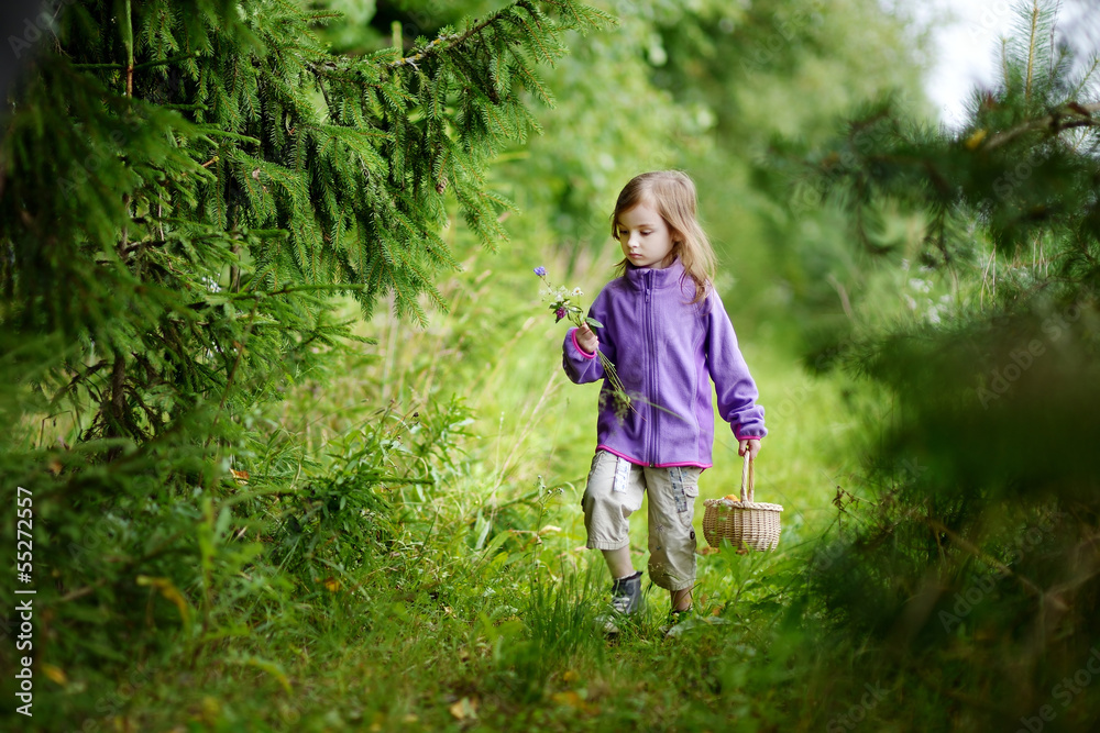 Adorable little girl hiking in the forest