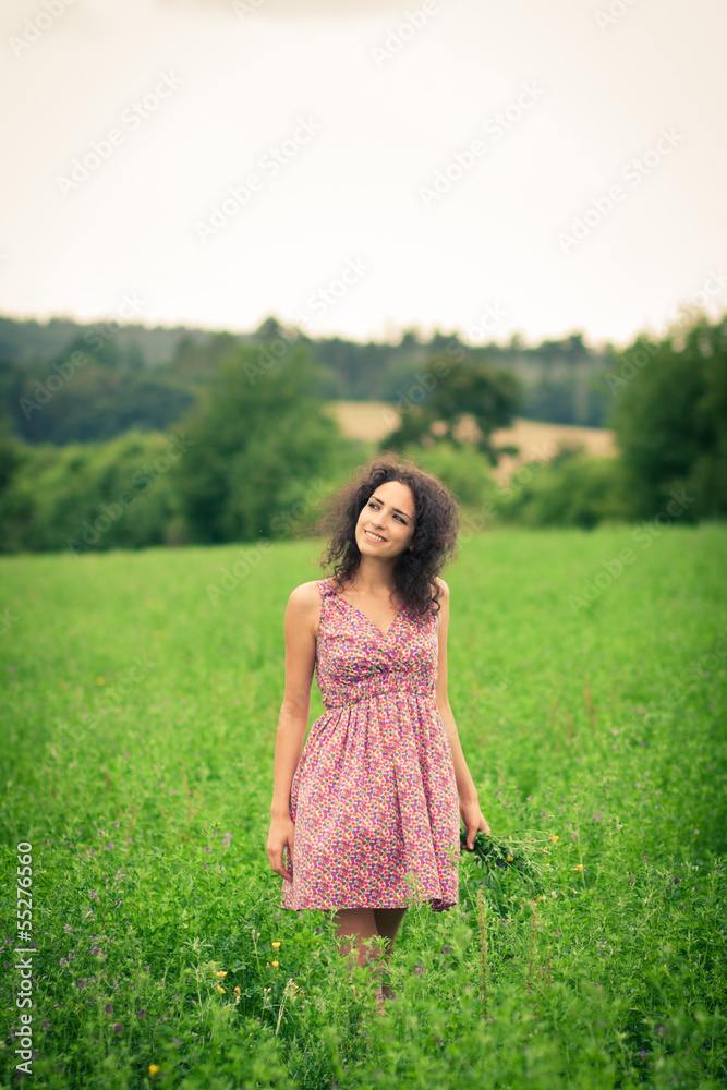 Beautiful young woman enjoying fresh air outdoors in a meadow Beautiful young woman enjoying fresh air outdoors in a meadow