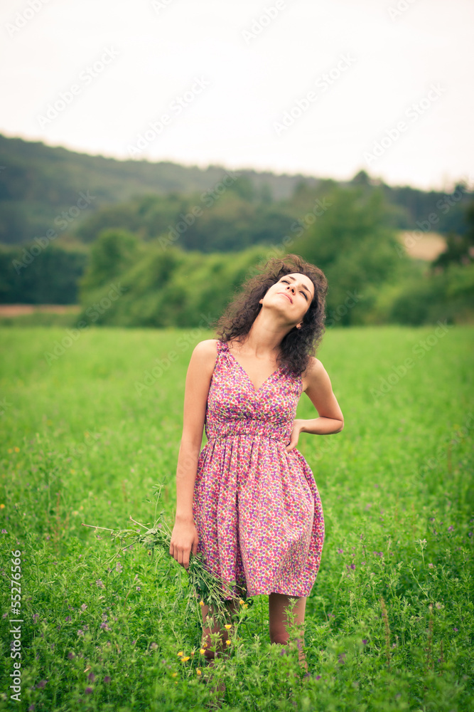 Beautiful young woman enjoying fresh air outdoors in a meadow Beautiful young woman enjoying fresh air outdoors in a meadow