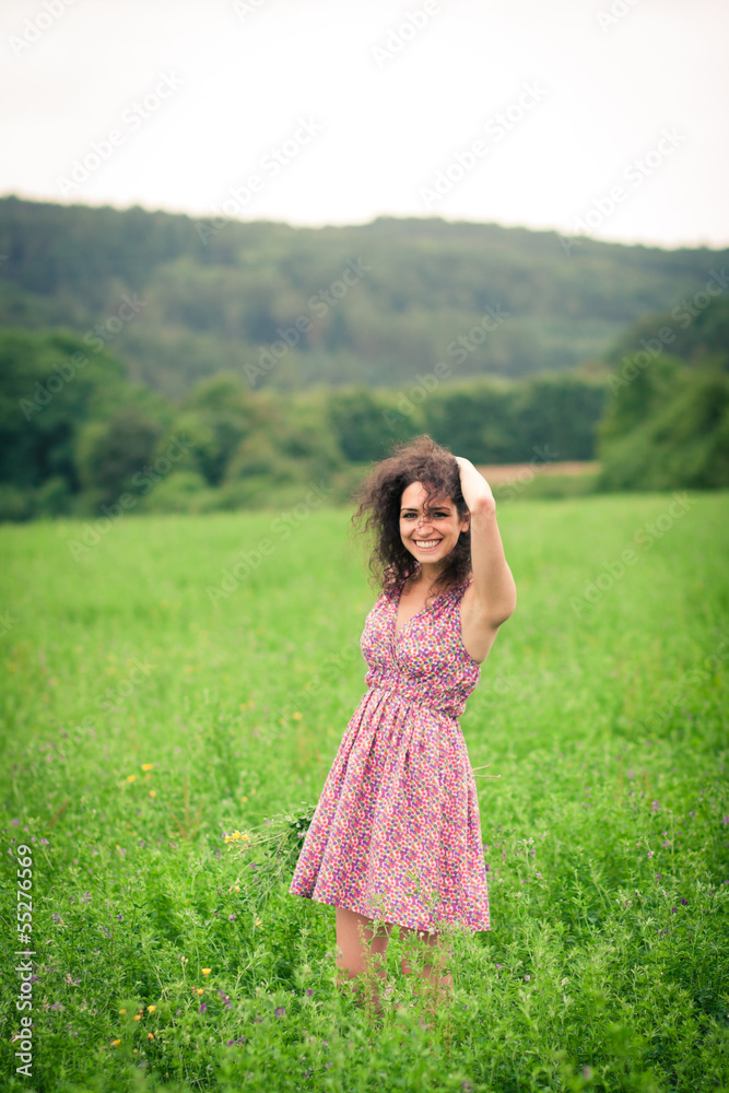 Beautiful young woman enjoying fresh air outdoors in a meadow Beautiful young woman enjoying fresh air outdoors in a meadow