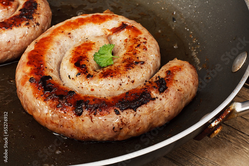 Bild auf Leinwand Frying Traditional Cumberland sausage