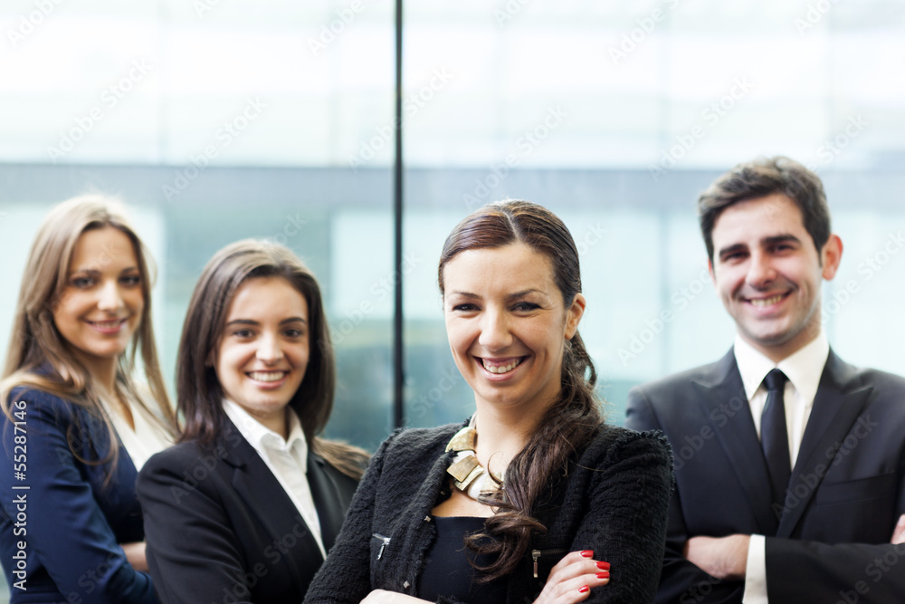 Businesswoman on the foreground of his collegues Businesswoman on the foreground of his collegues