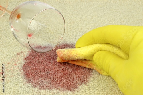 Cleaning up a spilled glass of red wine on a carpet