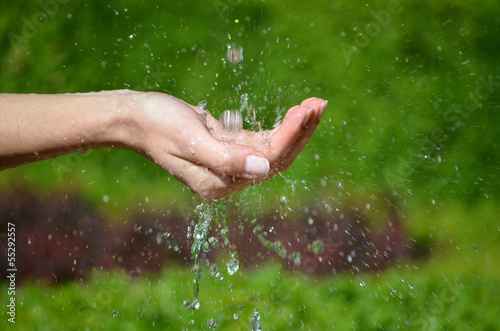 Woman's hand with water splash