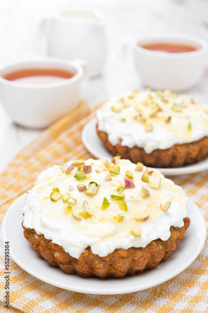 mini carrot cakes with cream of mascarpone and honey on a plate mini carrot cakes with cream of mascarpone and honey on a plate