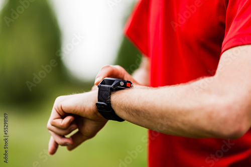 Runner looking at sports watch