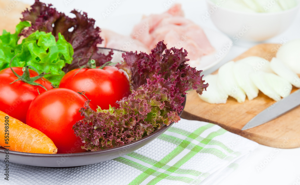 tomatoes and green salad in the bowl, on table tomatoes and green salad in the bowl, on table