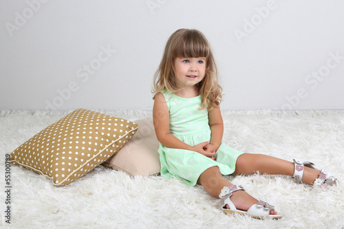 Little cute girl sitting on...