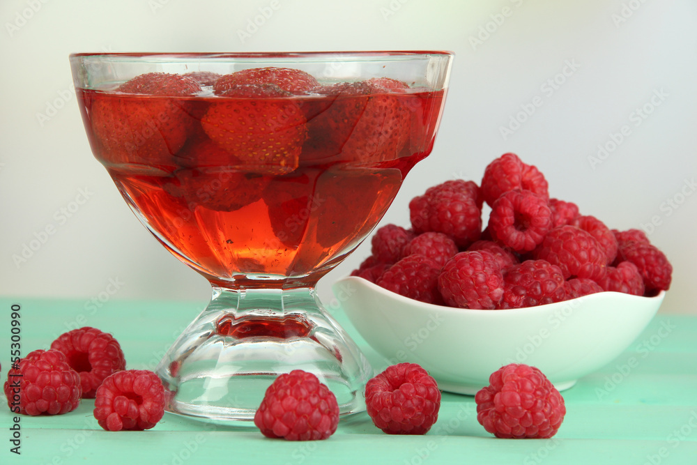 Jelly with fresh berries on green wooden table Jelly with fresh berries on green wooden table
