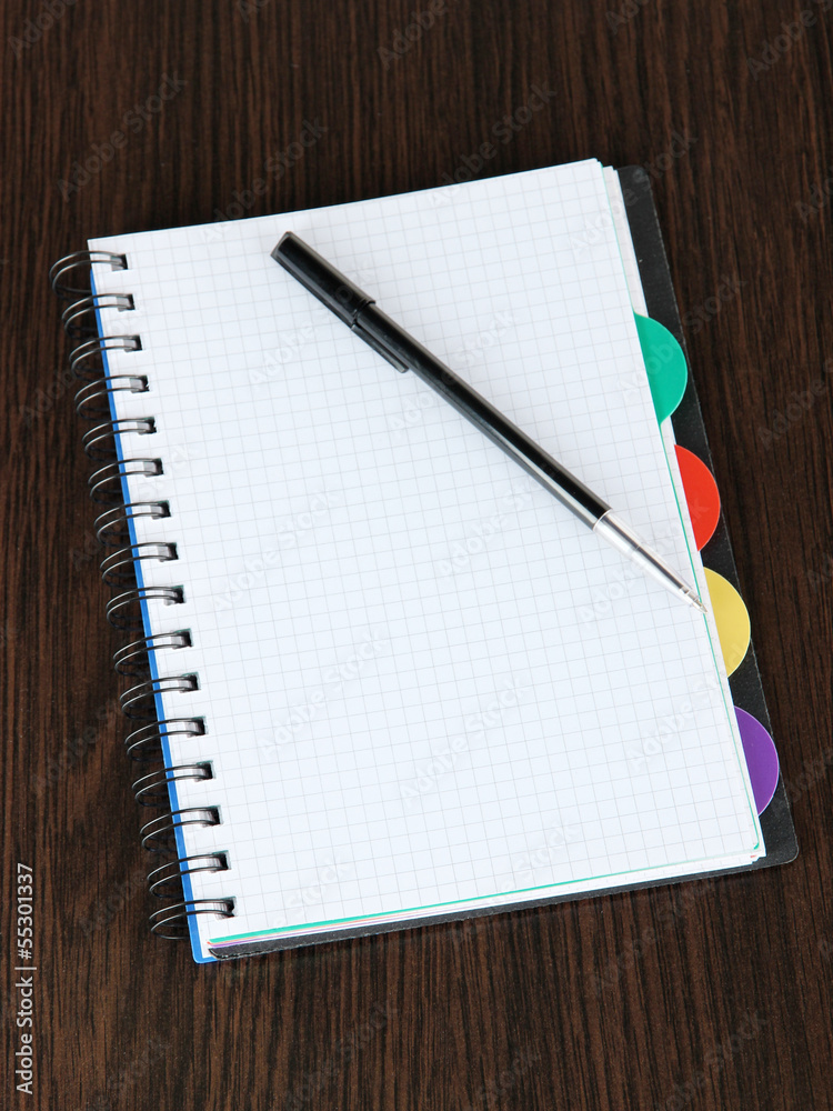 Notebook and pen on wooden table Notebook and pen on wooden table