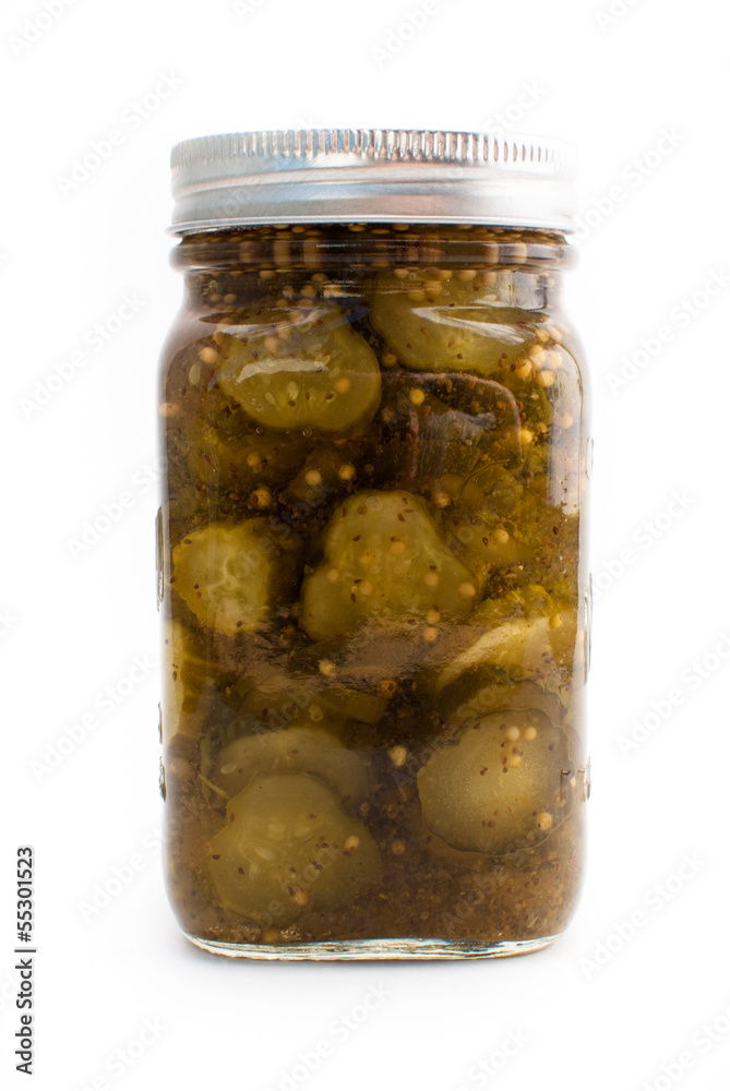 A jar of pickes in a mason jar on a white isolated background. A jar of pickes in a mason jar on a white isolated background.