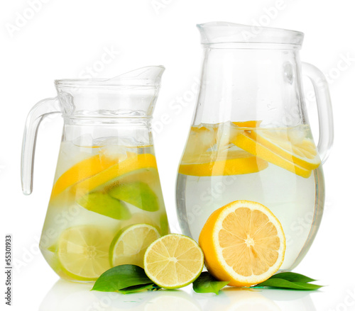 Cold water with lime, lemon and ice in pitchers isolated