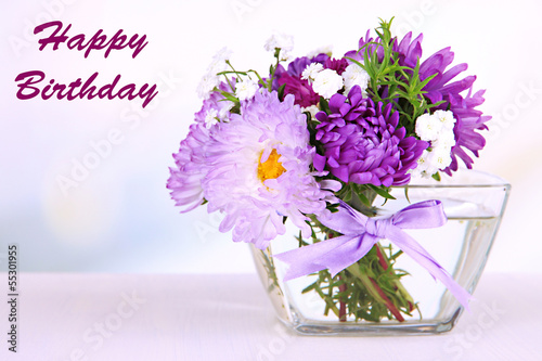 Fototapeta Naklejka Na Ścianę i Meble -  Beautiful bouquet of bright flowers in glass vase,