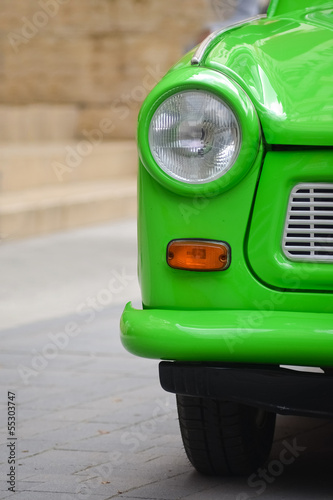 Canvas Print head light of a East-German plastic vintage car. Green Trabant