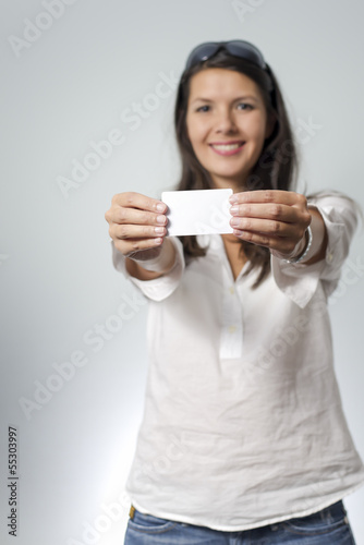 woman holds white plastic card