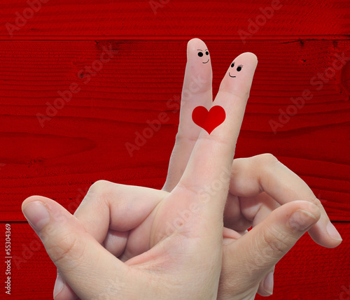 Conceptual love fingers on red wood