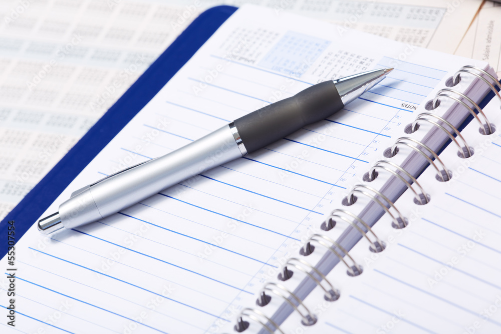 Pen and a notebook. Pen and a notebook.