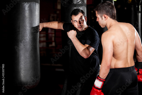 Boxer and coach training at a gym © AntonioDiaz