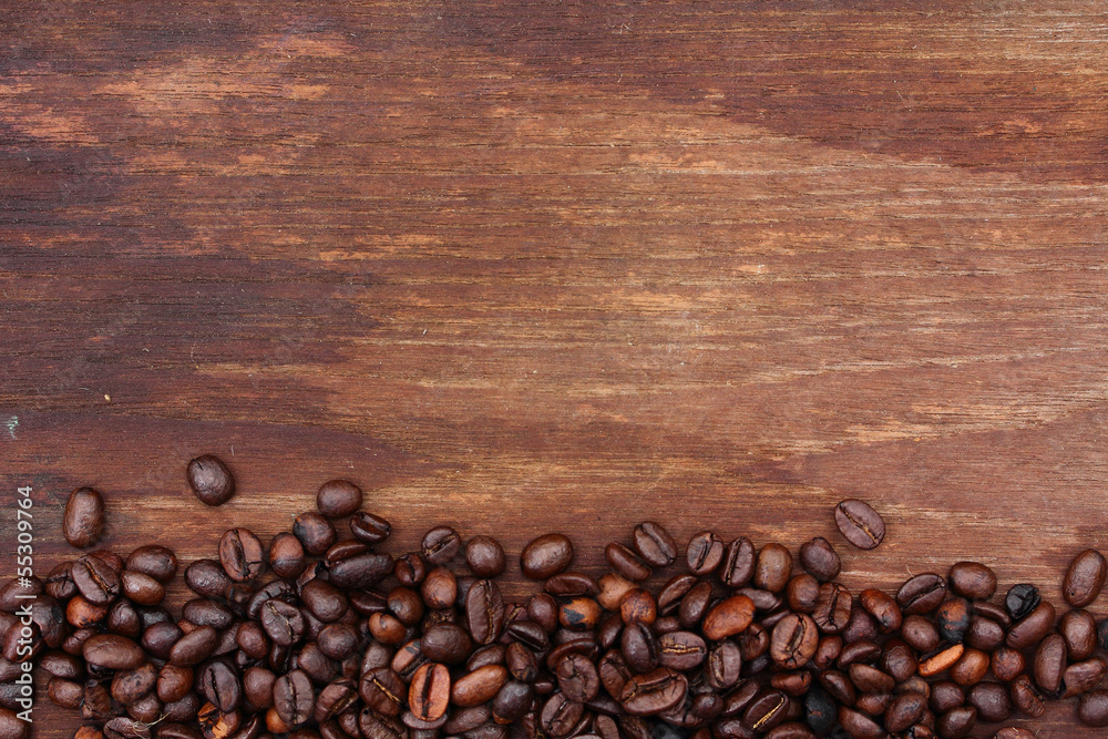 Fototapeta premium Fresh coffee beans on wood background