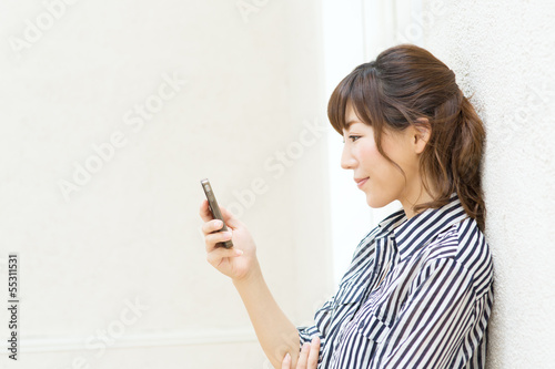 Beautiful young woman using a cellular