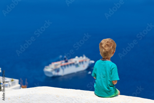 little boy looking at Santorini, Greece