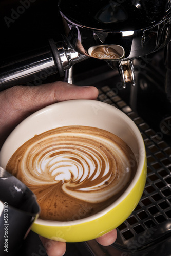 Barista pouring latte art