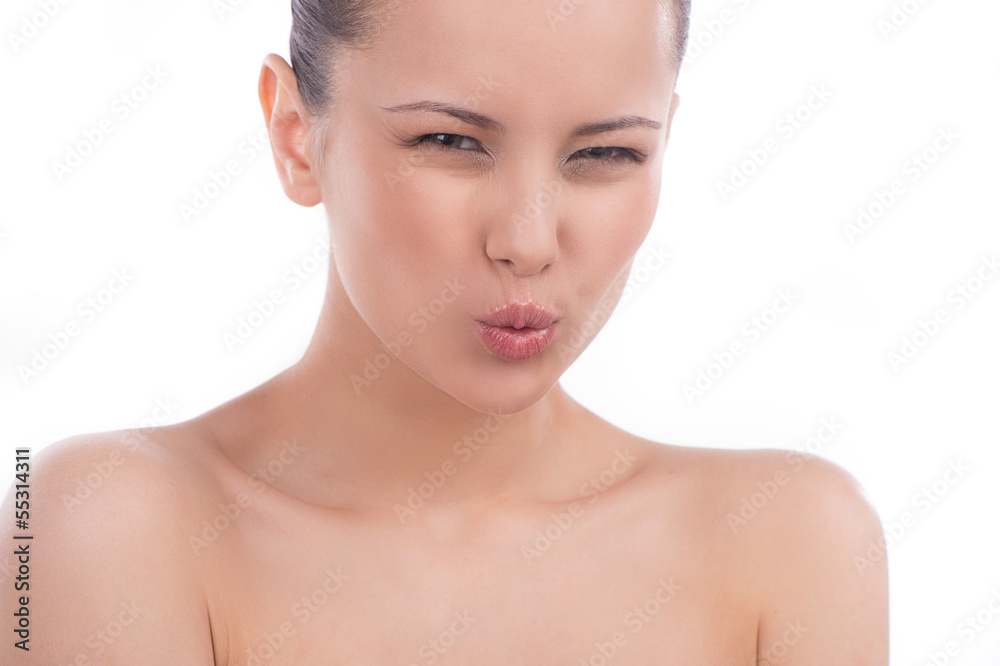 Woman making a face. Beautiful young woman grimacing and looking