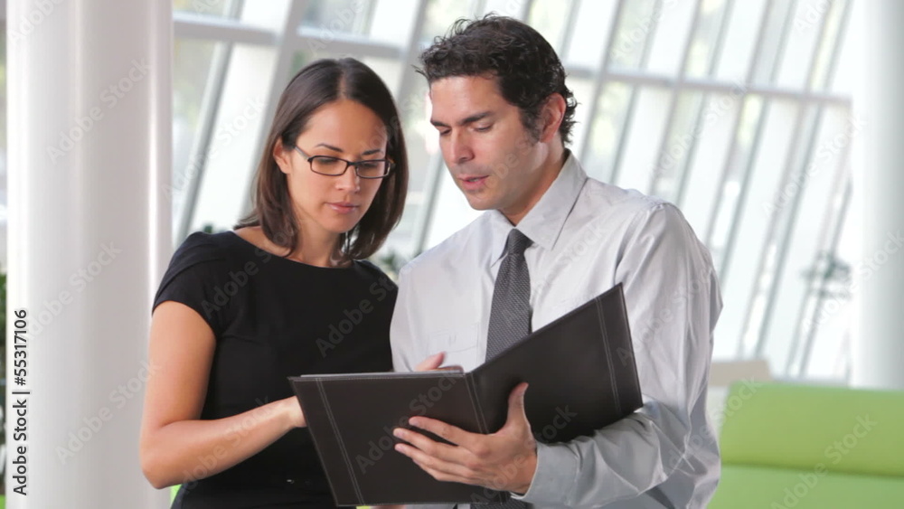 Businessman And Businesswomen Discussing Document Businessman And Businesswomen Discussing Document