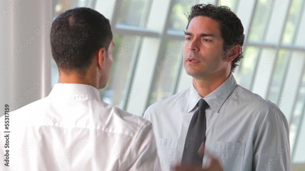 Two Businessmen Talking In Office Two Businessmen Talking In Office