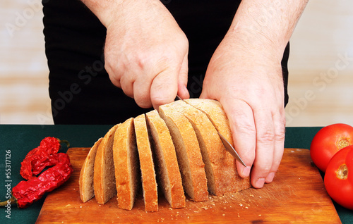 cook cuts the bread.